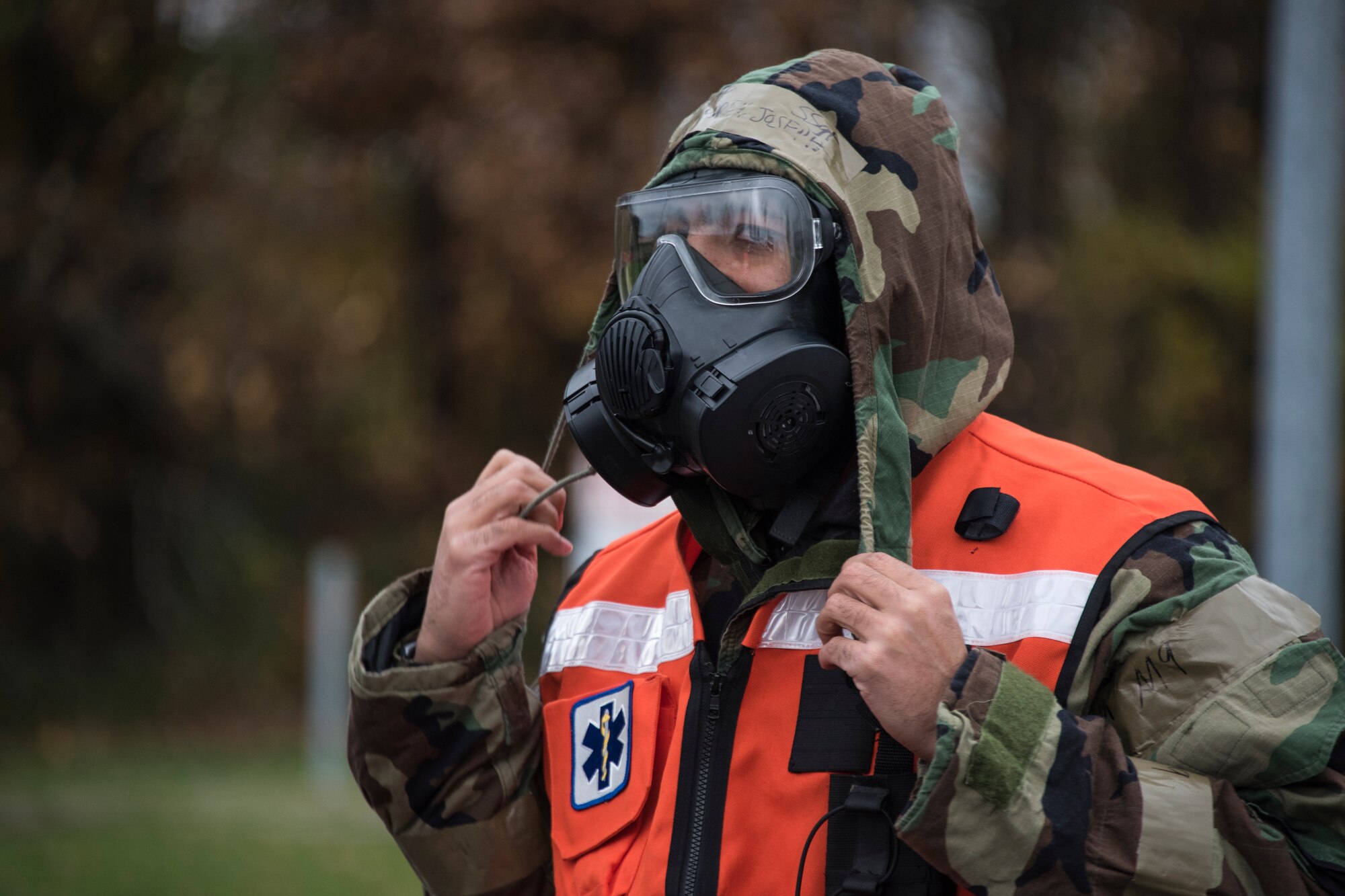 U.S. Air Force Staff Sgt. Joseph Lindgren, 52nd Dental Clinic technician, puts on chemical training gear before assisting with patient decontamination during an exercise at Spangdahlem Air Base, Germany, Nov. 17, 2020. Exercise mock patients are decontaminated before being moved into the medical clinic for further treatment. (U.S. Air Force photo by Senior Airman Chance D. Nardone)