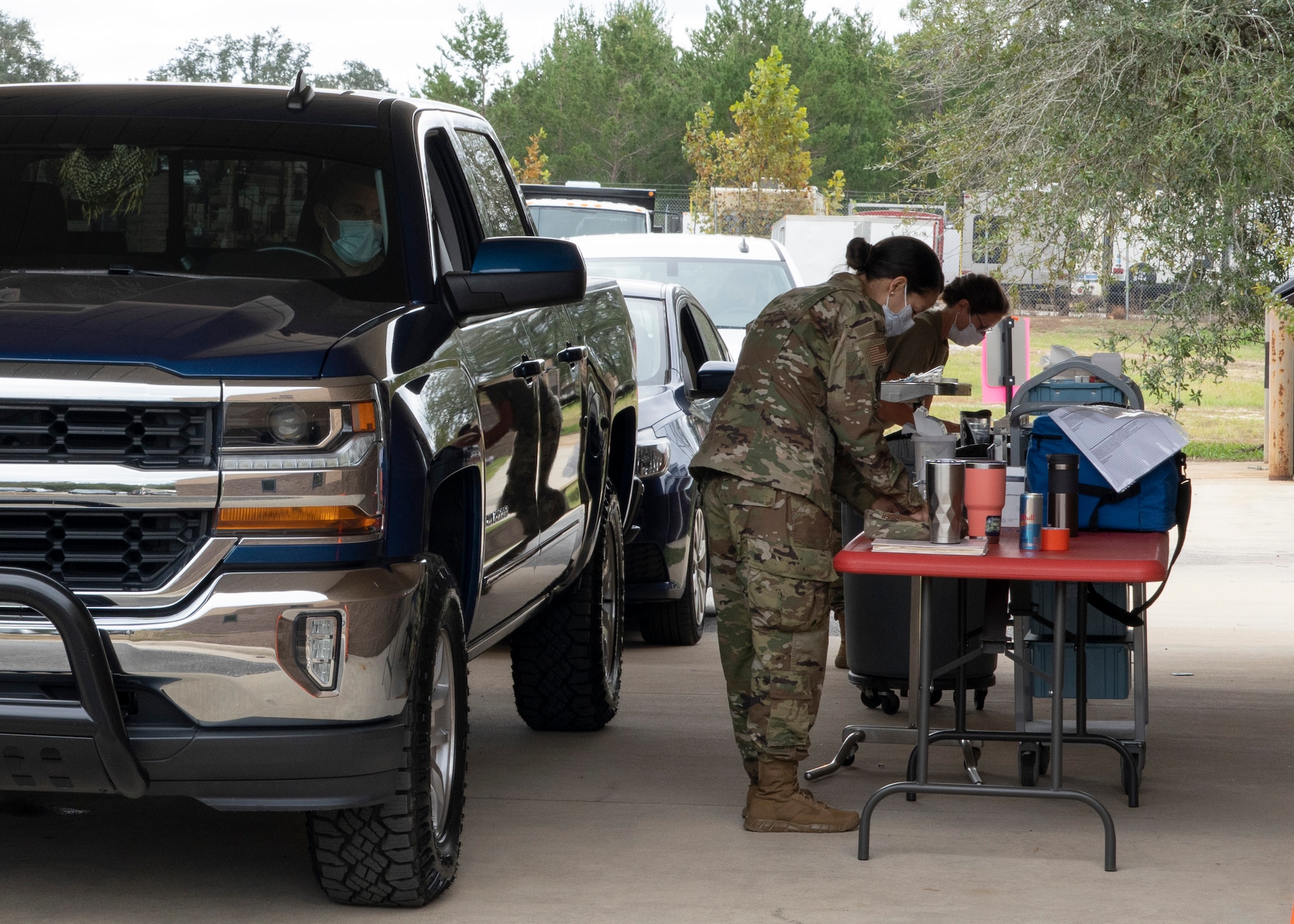 Photo of Airmen next to truck preparing flu vaccines