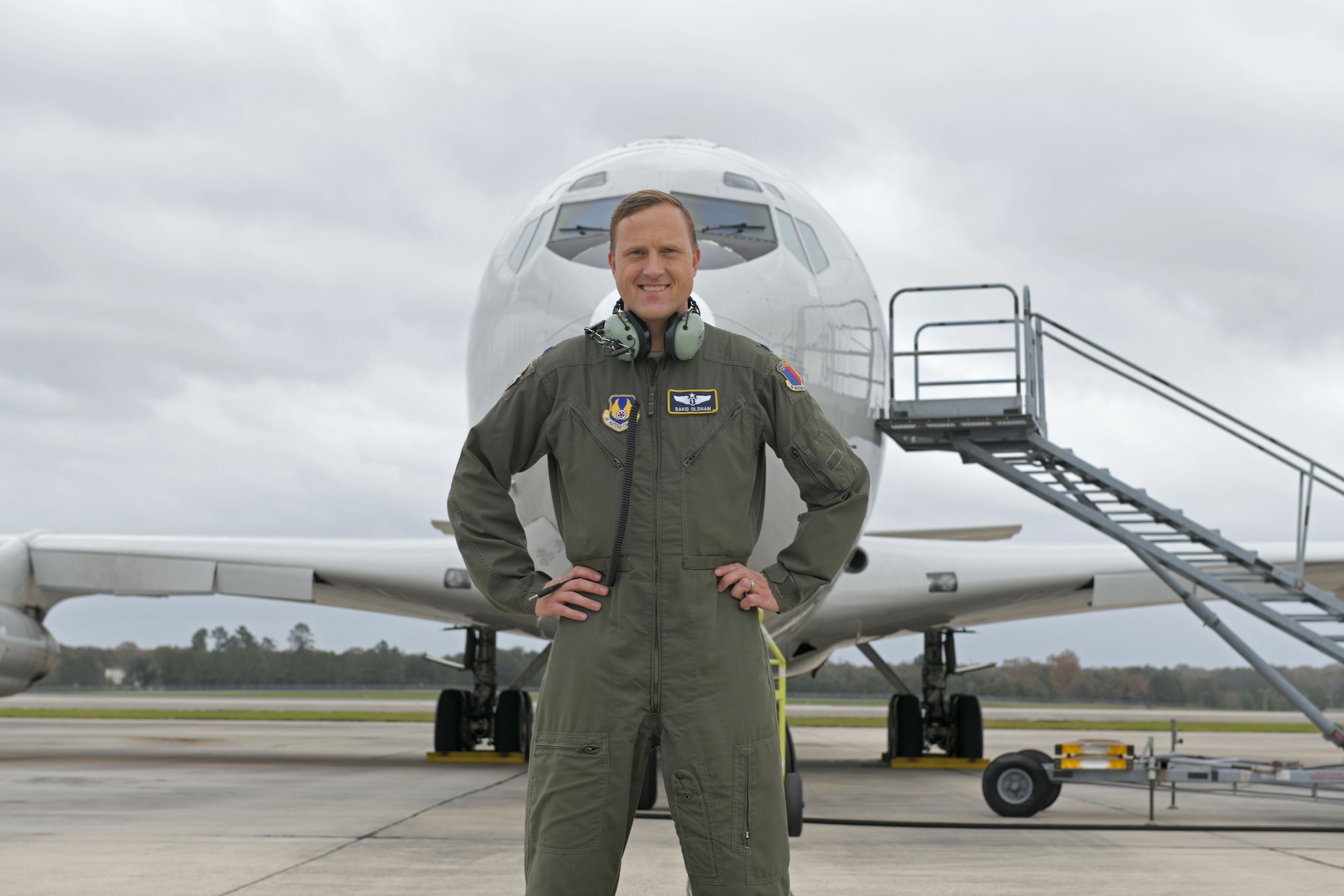 Photo shows man standing in front of aircraft.