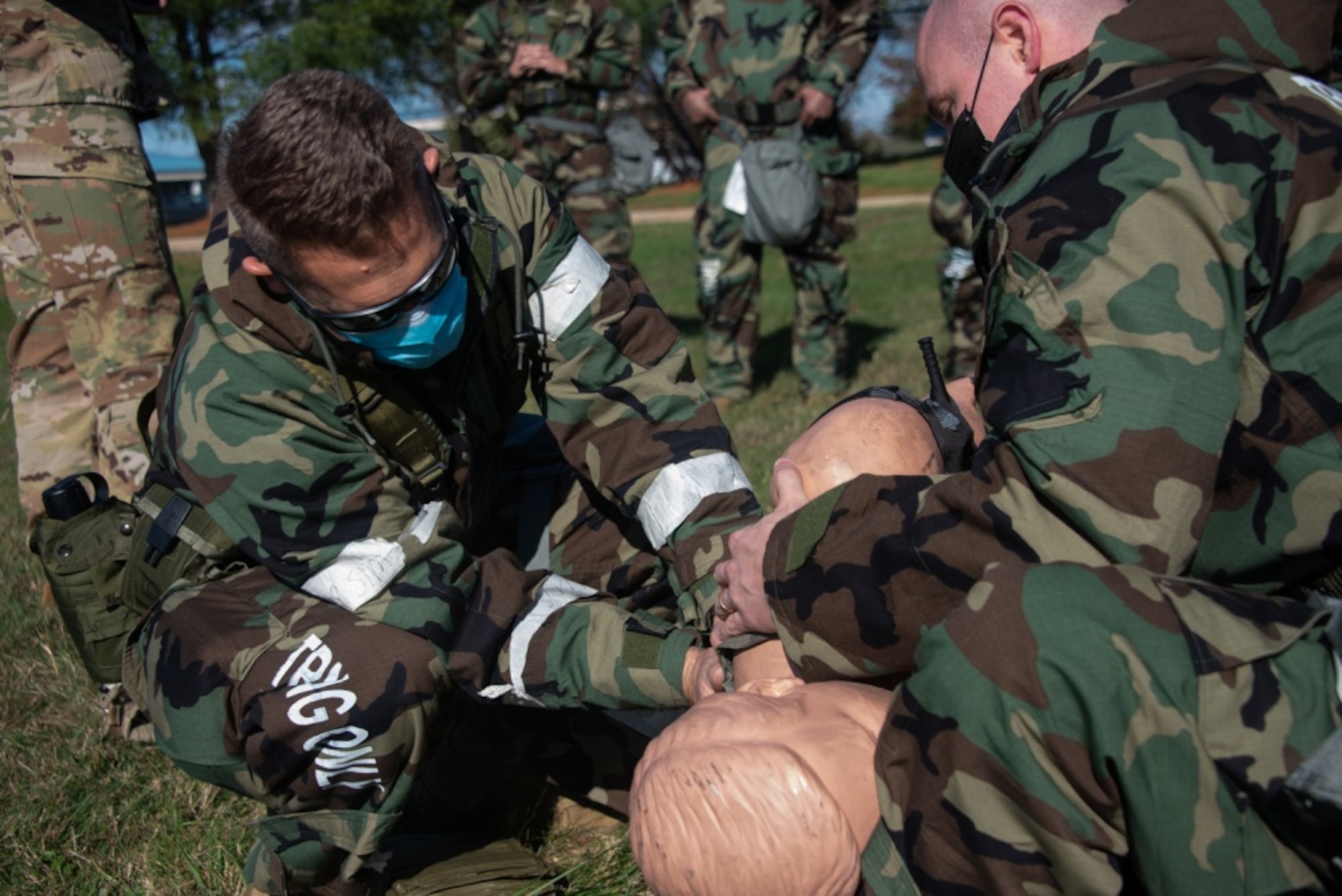 Airmen from the 108th Wing set a mock patient on a litter to be transported as part of a Medical Evacuation and Tactical Combat Casualty Care training on Joint Base McGuire-Dix-Lakehurst, N.J., Nov. 16, 2020. The MEDEVAC TCCC training gives a basic understanding of how service members can apply emergency triage in any applicable situation in a deployed environment. (U.S. Air Force photo by Airman 1st Class Joseph Morales)