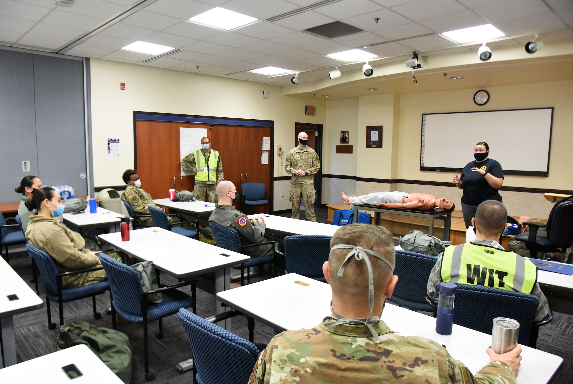 U.S. Air Force Maj. Gyasi Mann, 108th Medical Group public health officer, U.S. Air Force Staff Sgt. Craig Virginia, 421st Combat Training Squadron tactical combat casualty care NCOIC and Barbara Hoyt, 421st CTS contingency skills instructor, teach participants about the fundamentals of TCCC at the 108th MDG training classroom, Nov. 16, 2020, on Joint Base McGuire-Dix-Lakehurst, N.J. The training helps participants provide casualty treatment care during combat operations. (U.S. Air Force photo by Daniel Barney)