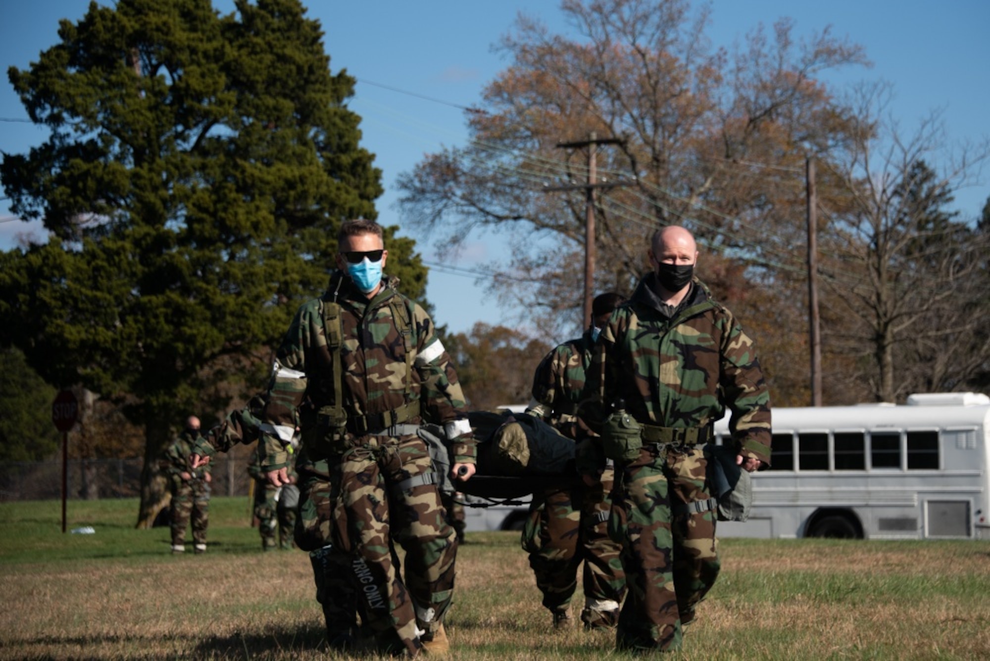 Airmen from the 108th Wing transport a mock patient on a litter as part of a Medical Evacuation and Tactical Combat Casualty Care training on Joint Base McGuire-Dix-Lakehurst, N.J. Nov. 16, 2020. The MEDEVAC TCCC training gives a basic understanding of how service members can apply emergency triage in any applicable situation in a deployed environment. (U.S. Air Force photo by Airman 1st Class Joseph Morales)