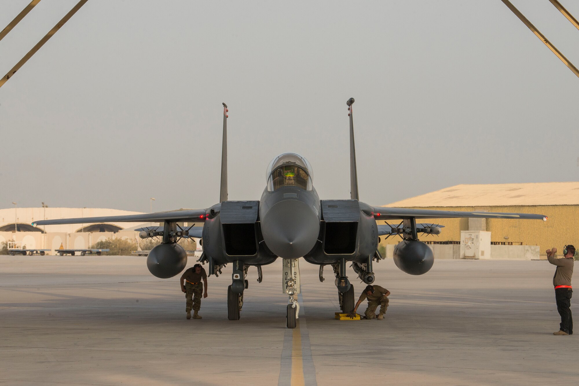 U.S. Airmen assigned to the 332nd Air Expeditionary Wing perform post-flight procedures on a U.S. Air Force F-15E Strike Eagle assigned to the 332nd AEW on the flightline at Al Dhafra Air Base, United Arab Emirates, Nov. 17, 2020.