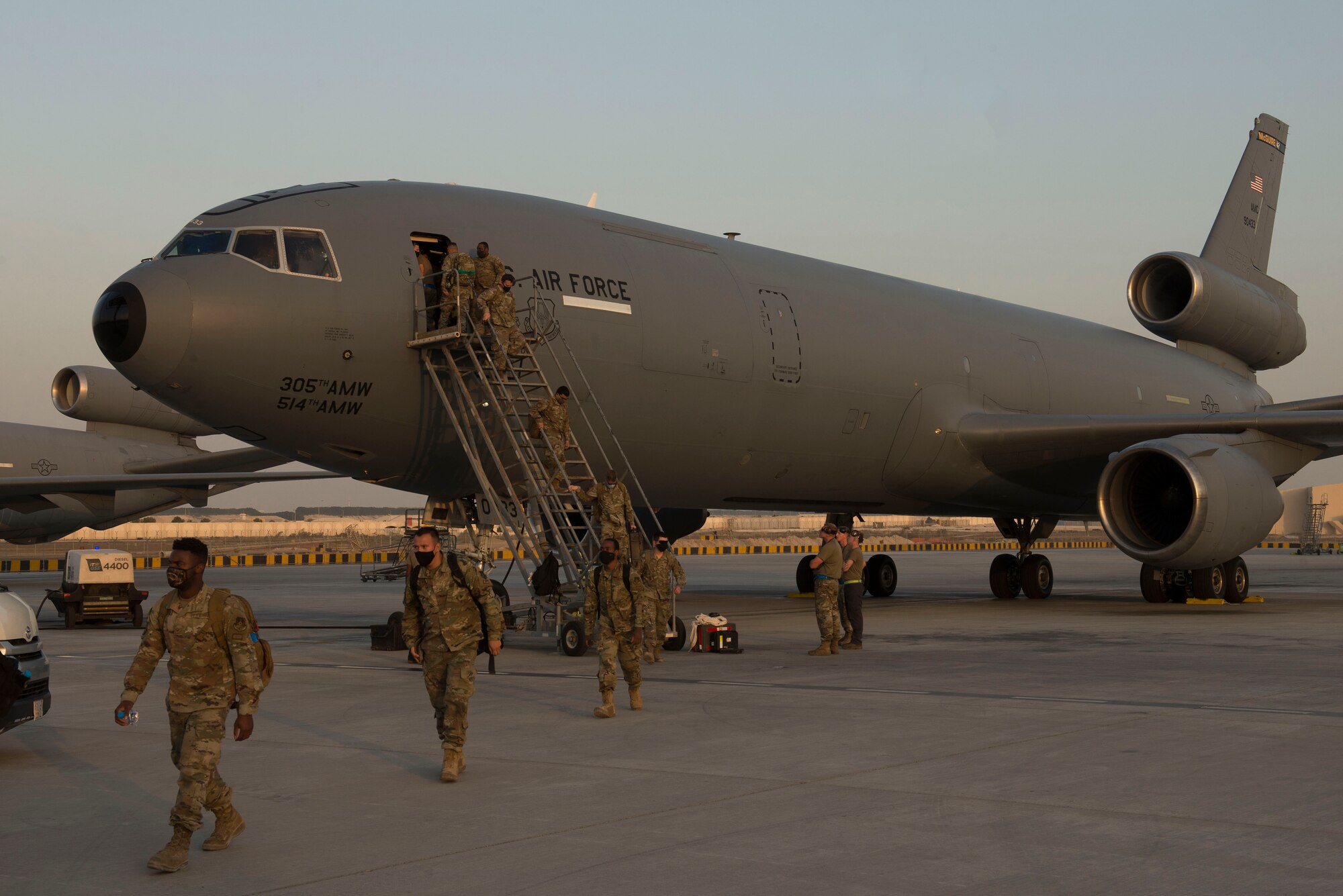 U.S. Airmen assigned to the 332nd Air Expeditionary Wing disembark from a U.S. Air Force KC-10 Extender assigned to the 908th Expeditionary Air Refueling Squadron at Al Dhafra Air Base, United Arab Emirates, Nov. 16, 2020.