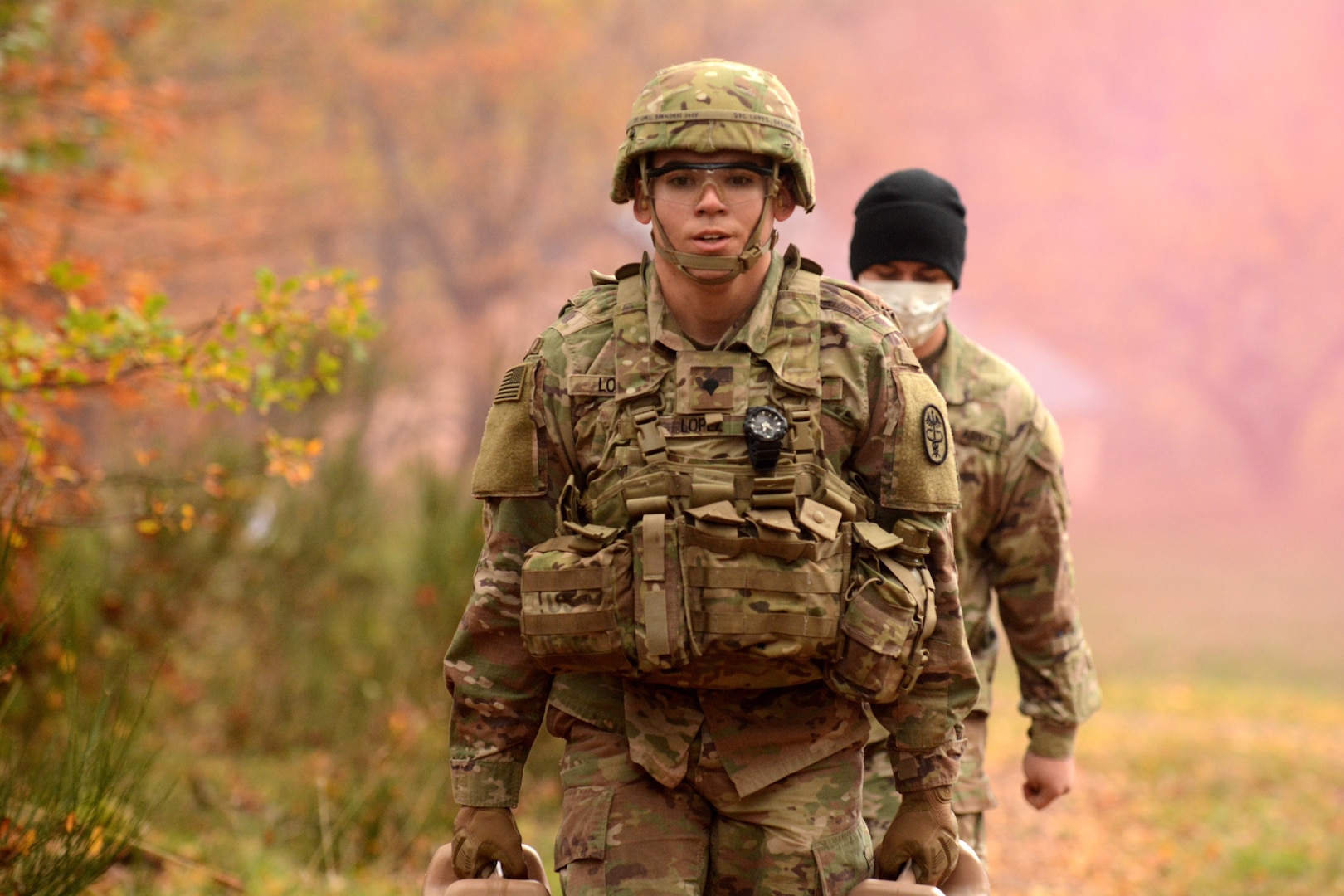 Spc. Brenden Lopez, assigned to U.S. Army Medical Department Activity-Bavaria, carries water jugs during the stress shoot portion of the Regional Health Command Europe Best Warrior competition Nov. 3 and 4 in Baumholder.  Lopez was the winner in the 'Soldier' category.