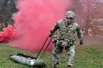 Spc. Walter Galdamez, assigned to U.S. Army Medical Department Activity-Bavaria, pulls a simulated injured Soldier on a SKEDCO during the Regional Health Command Europe Best Medic competition.  Galdamez was one half of the team that earned the Best Medic title.