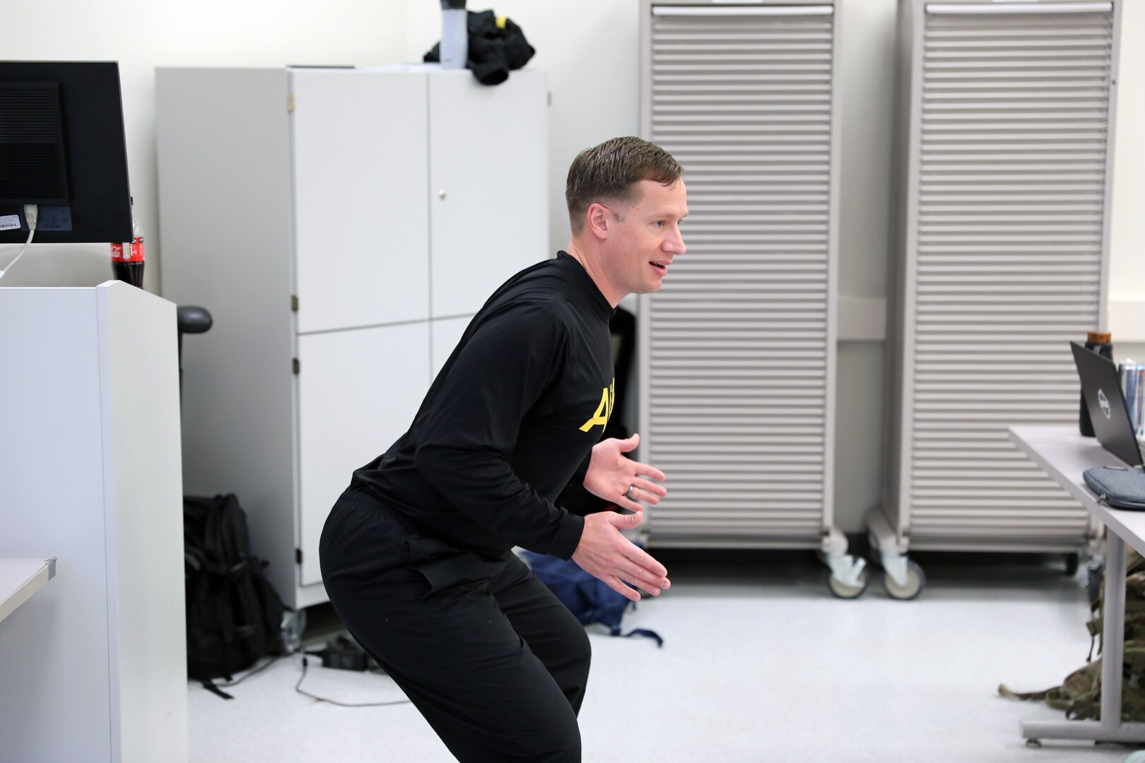 Capt. Daniel Huffman, a physical therapist at Landstuhl Regional Medical Center, demonstrates proper squat technique during a physical readiness training leadership course.