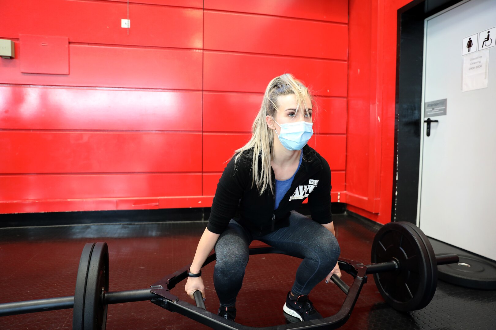 Becky Roberts, a health educator at the Landstuhl Army Wellness Center, practices proper deadlift technique during a physical readiness training leadership course.