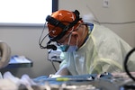 Col. (Dr.) Tom Goksel, an oral maxillofacial surgeon, prepares for surgery.