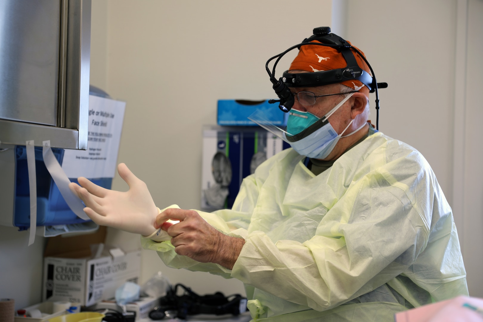 Col. (Dr.) Tom Goksel, an oral maxillofacial surgeon, prepares for surgery.