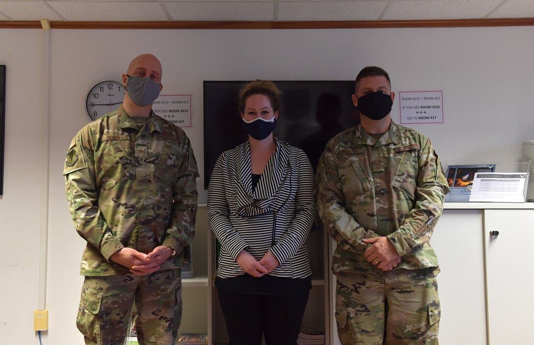 Korinna Inman, 86th Force Support Squadron formal training manager, (center) poses for a photo with U.S. Air Force Brig. Gen. Josh Olson, 86th Airlift Wing commander (left) and U.S. Air Force Chief Master Sgt. Miller 86th Mission Support Group superintendent, (right).