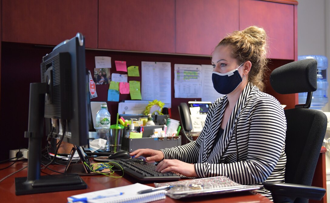 Korinna Inman goes over training documents at her desk.