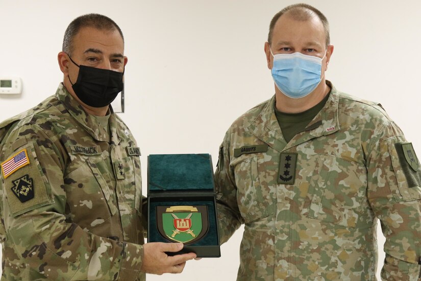 Maj. Gen. Mark McCormack (left), 28th Infantry Division commander receives a plaque Nov 14 from Lithuanian Land Forces OF-5 Zilvinas Gaubys in recognition of the 28 ID’s longstanding partnership with Lithuania. (U.S. Army photo by Master Sgt. Daniel Palermo)