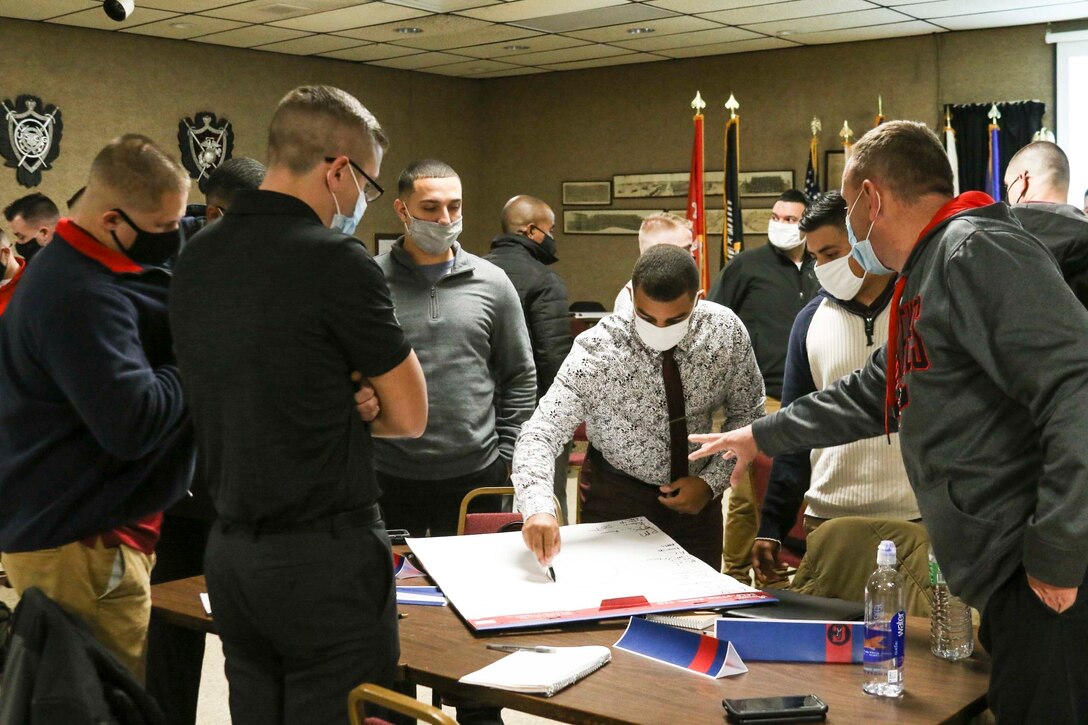 U.S. Marine recruiters, with Recruiting Station Cleveland, participate in a learning activity during refresher and reinforcement (R&R) training in Freemont, Ohio, Oct. 30, 2020. The purpose of R&R training is to inform the recruiters about future goals  to meet the recruiting stations objective. (U.S. Marine Corps photo by Cpl. Nello Miele)