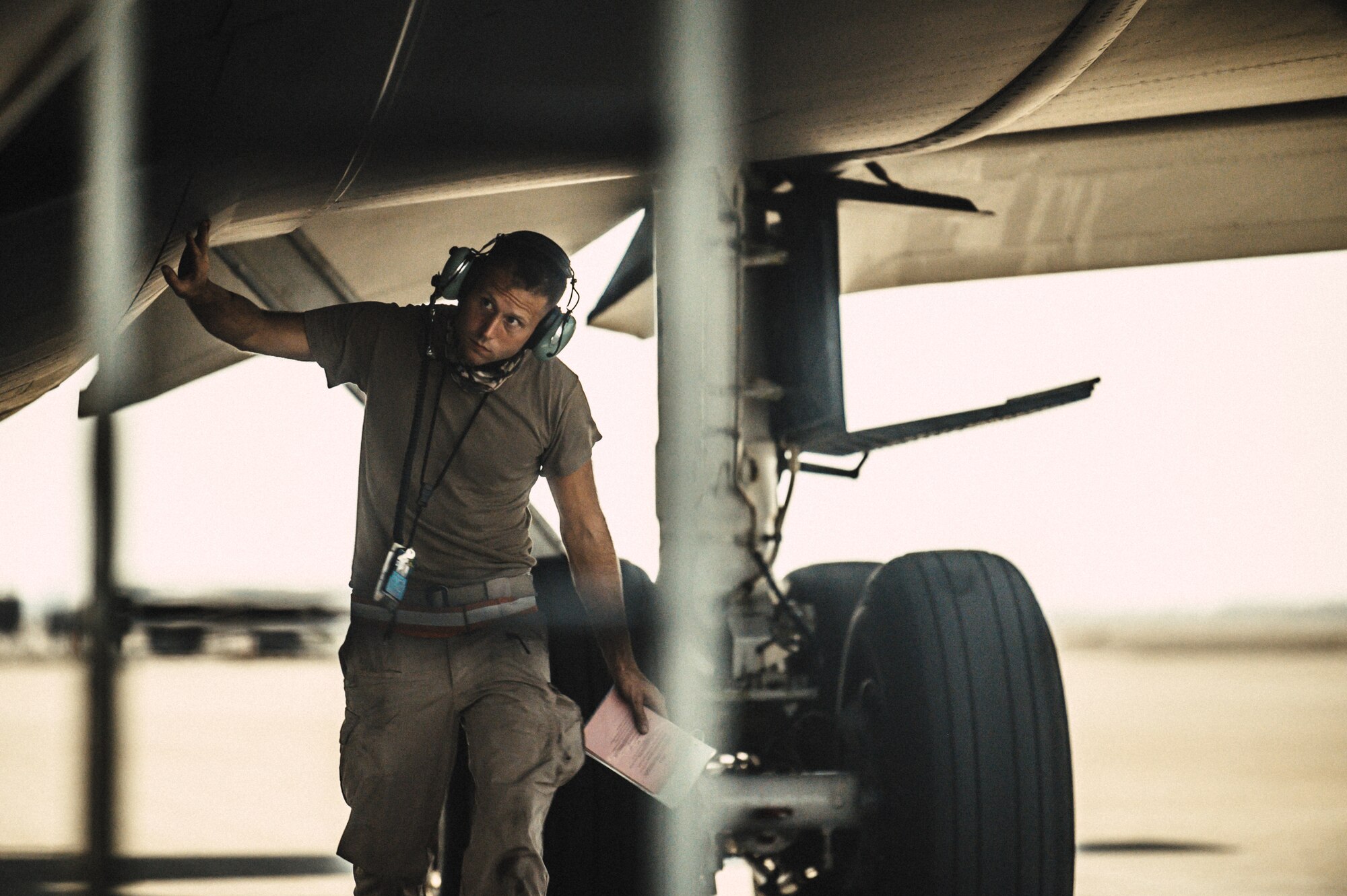 U.S. Air Force Staff Sgt. Alexander Kelly, crew chief, 379th Expeditionary Air Maintenance Squadron, performs a preflight inspection on a KC-135 Stratotanker at Al Udeid Air Base, Qatar, Nov. 18, 2020. Alongside the 379th Expeditionary Logistics Readiness Squadron, the 379th EAMXS conducted a hot-refueling training, qualifying deployed Airmen to refuel the KC-135 while its engines remained running. This capability allows KC-135 flight crews to rapidly return to their mission in the CENTCOM area of responsibility. (U.S. Air National Guard photo by Staff Sgt. Jordan Martin)