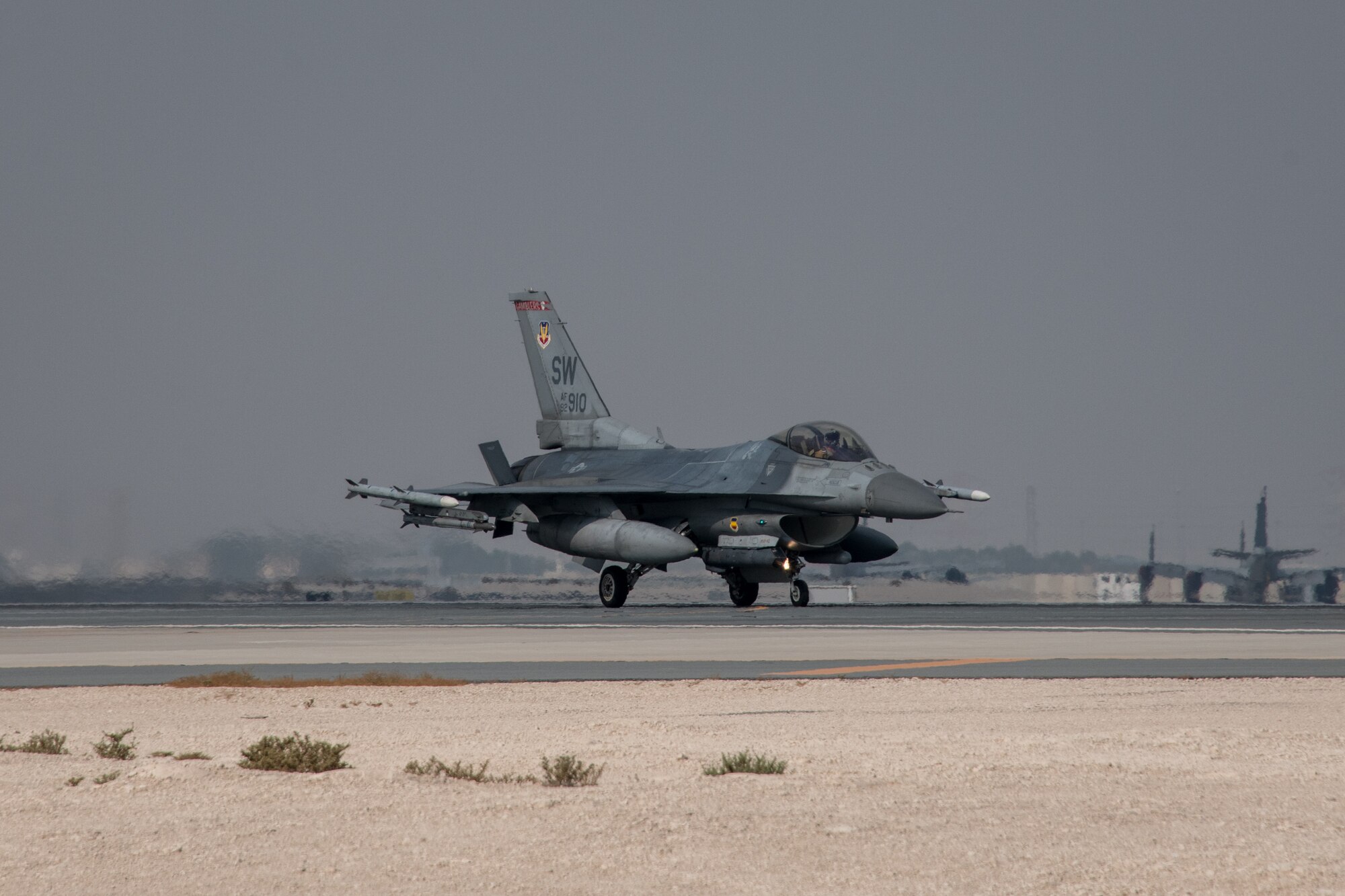 An F-16 Fighting Falcon, assigned to the 77th Expeditionary Fighter Squadron deployed to Prince Sultan Air Base, Kingdom of Saudi Arabia, lands on a runway at Al Udeid Air Base, Qatar, as it heads in for hot pit refueling Nov. 9, 2020. The training qualified deployed Airmen assigned to the 379th Maintenance Group and 379th Expeditionary Logistics Readiness Squadron to perform 24-hour hot pit refueling operations on multiple aircraft that rotate through AUAB. Hot refueling allows aircrew to land and keep their aircraft engines running while they refuel, before taking off to continue the next leg of their respective missions. (U.S. Air National Guard photo by Tech. Sgt. Brigette Waltermire)