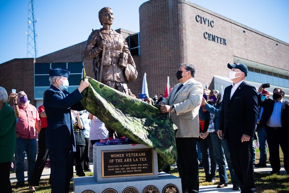 Lorenz Walker, Bossier City mayor and retired U.S. Air Force colonel, and Joey Strickland, Louisiana Department of Veterans Affairs secretary, unveil the Women Veterans of the Ark-La-Tex statue at the Bossier City Civic Center in Bossier City, La., Nov. 11, 2020. The Women Veterans of the Ark-La-Tex statue is dedicated to the women, past and present, who have served in the U.S. military. (U.S. Air Force photo by Airman 1st Class Jacob B. Wrightsman)
