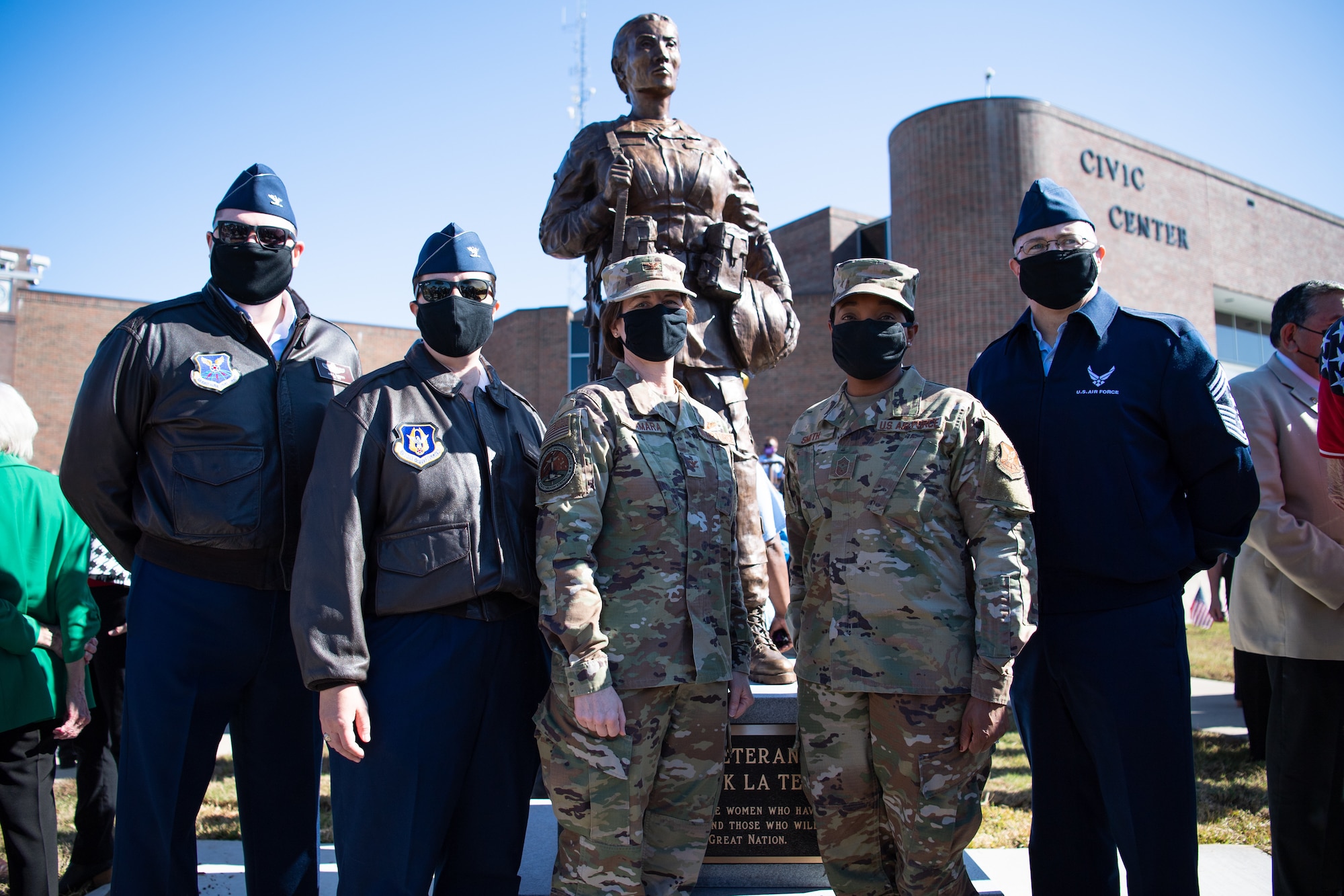 Leaders from Barksdale Air Force Base, La., pose for a photo in front of the newly unveiled Women Veterans of the Ark-La-Tex statue at the Bossier City Civic Center in Bossier City, La., Nov. 11, 2020. The statue was unveiled during a Veteran's Day celebration at the Bossier City Civic Center. (U.S. Air Force photo by Airman 1st Class Jacob B. Wrightsman)