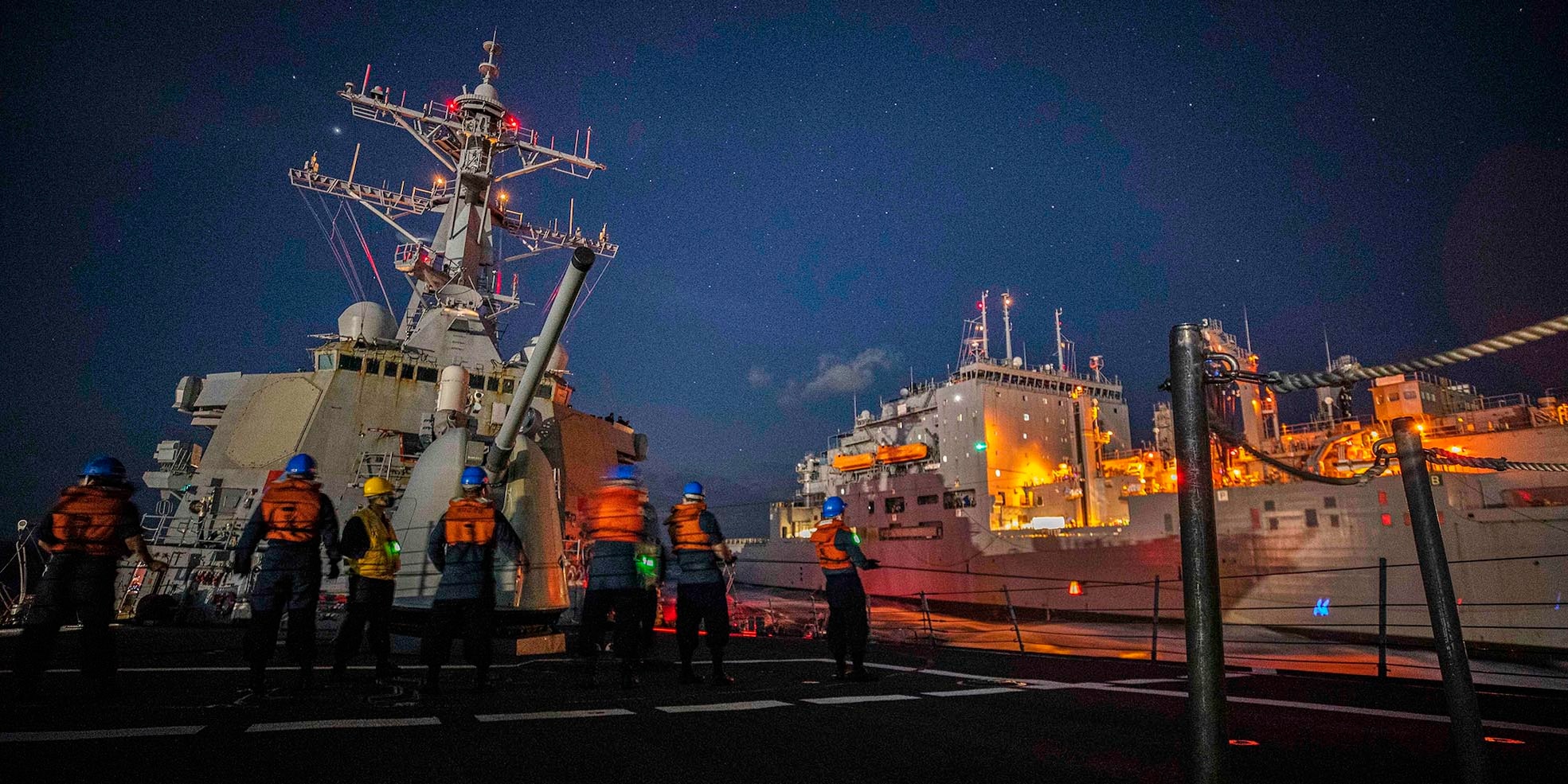 The Arleigh Burke-class guided-missile destroyer USS John S. McCain (DDG 56) conducts a replenishment-at-sea with the Lewis and Clark-class dry cargo and ammunition ship USNS Charles Drew (T-AKE 10).