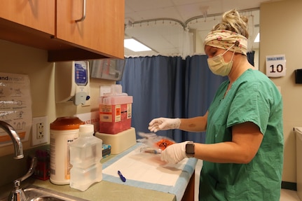 U.S. Army Staff Sgt. Kirsti Horton, a combat medic with the Marietta-based Georgia Medical Detachment, 78th Troop Command, Georgia Army National Guard, labels a patient's test vials on May 14, 2020, at Wellstar Atlanta Medical Center South in East Point, Georgia. The Georgia Army National Guard deployed Soldiers and Airmen to local hospitals to increase medical staffing.