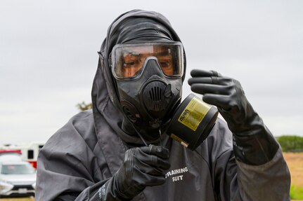 Spc. Isaac Acosta, 68th Engineer Construction Company horizontal engineer, pulls his hazmat suit over his protective mask during the Urban Search and Rescue lane at the San Antonio Fire Academy Nov. 6. This lane is part of a larger exercise run by U.S. Army North's Civil Support Training Activity, a unit comprised of teams that train with state and regional forces on a range of tiered chemical, biological, radiological and nuclear technical tasks that aid in the effective support of civil authorities during a response.