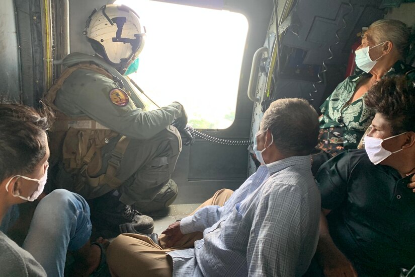 A group of people sit in a helicopter.