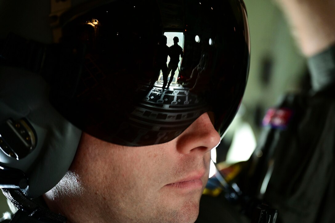 The reflection of service members is seen through an airman’s glasses.