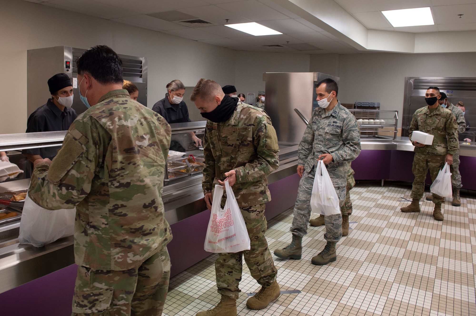 Grissom Airmen socially distance as they grab lunch to-go at the Grissom dining facility on November 8. The dining facility took many persuasions to ensure the safety of airmen assigned to Grissom, including a carry out only option for food during the unit training assembly. (U.S. Air Force Photo by Tech Sgt. Jami Lancette)