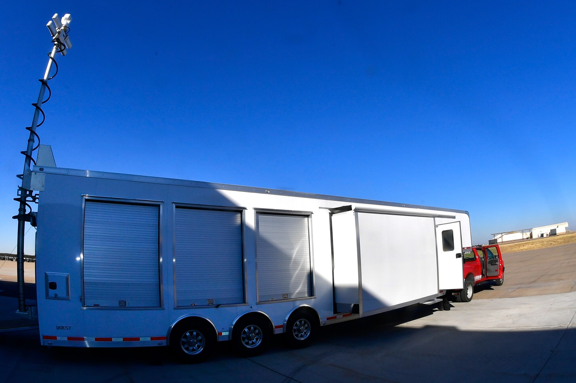 The MEOC trailer hooked to the back of a red pick up truck.