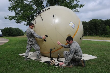 U.S. Air Force Airman 1st Class Coleton Barberree (left) and Master Sgt. Chad W. White, Radio Frequency Transmission specialists, 280th Combat Communications Squadron, Alabama Air National Guard, adjust a GATR (Ground Antenna Transmit and Receive) during the Hope of Martin Innovative Readiness Training (IRT) at Martin Middle School in Martin, Tenn., July 15.