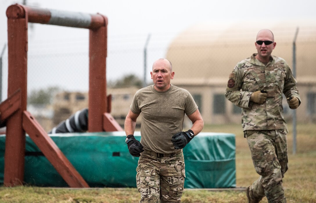 Master Sgts. Christopher Beversdorf and Derek Guerin, both 330th Recruiting Squadron special warfare recruiters, ran the obstacle course in chilling temperatures during the 2020 Lightning Challenge at Fort Hood, Texas, Oct. 26, 2020. Lightning Challenge was a service-wide competition where teams of two Tactical Control Party Airmen specialists competed against each other to be named the best in the Air Force. Beversdorf, a TACP by trade uses his operational knowledge of the career-field to ensure recruits have the best information possible when making decisions. (U.S. Air Force photo by Master Sgt. JT May III)