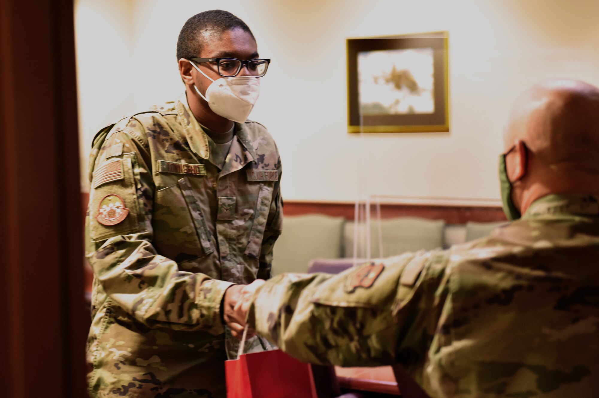 U.S. Air Force Col. Andres Nazario, 17th Training Wing commander, hands a casual student a goodie bag in the Norma Brown Building on Goodfellow Air Force Base, Texas, Nov. 17, 2020. Causal students may work in a variety of capacities while waiting to begin training. (U.S. Air Force photo by Airman 1st Class Dominique Parham)