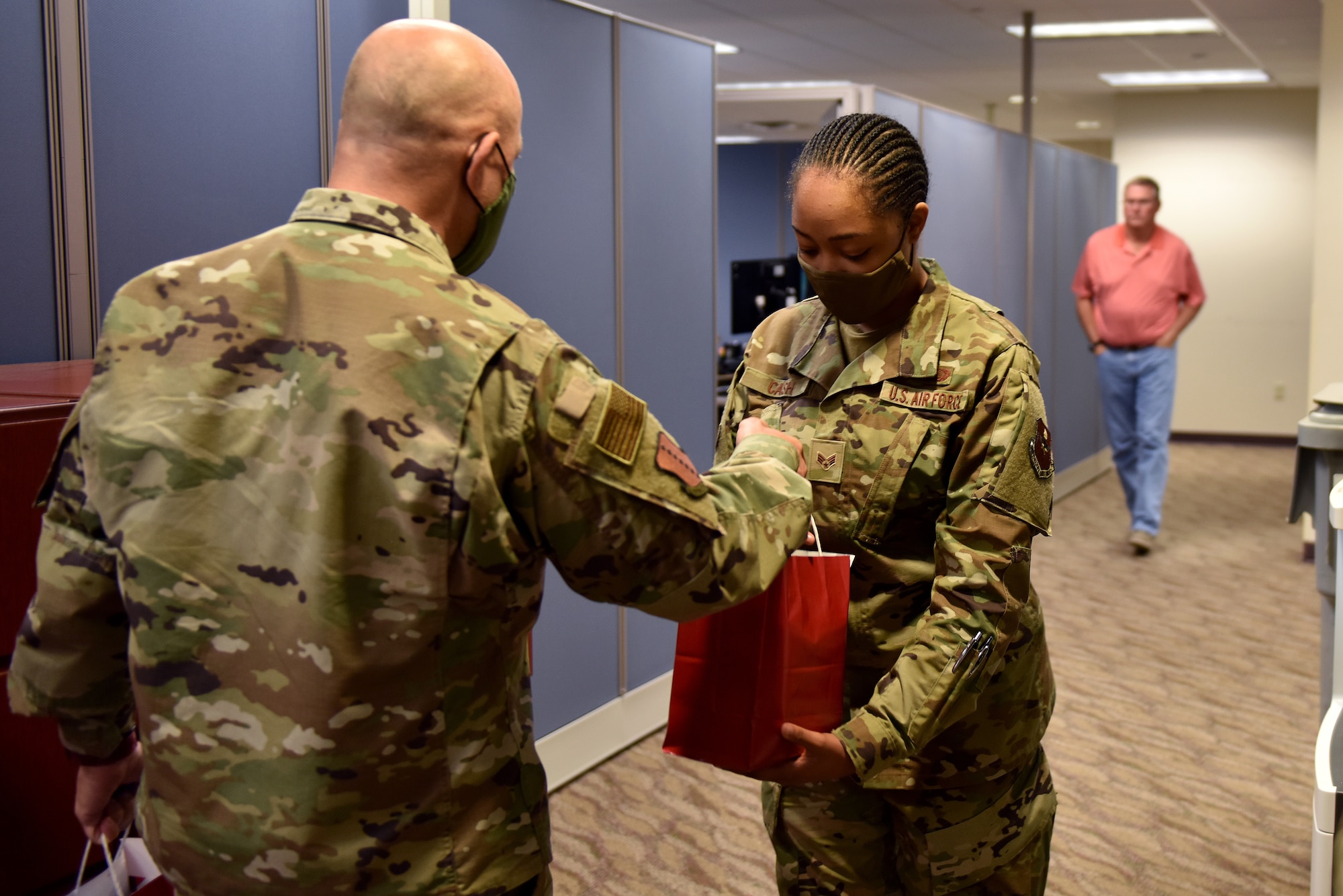 U.S. Air Force Col. Andres Nazario, 17th Training Wing commander, hands Senior Airman Brianna Cash a goody bag in the Norma Brown Building on Goodfellow Air Force Base, Texas, Nov. 17, 2020. The goody bags were filled with a variety of seasonal items such as; cookies, coffee, creamer, and a note from a community member thanking the military for their service. (U.S. Air Force photo by Staff Sgt. Seraiah Wolf)