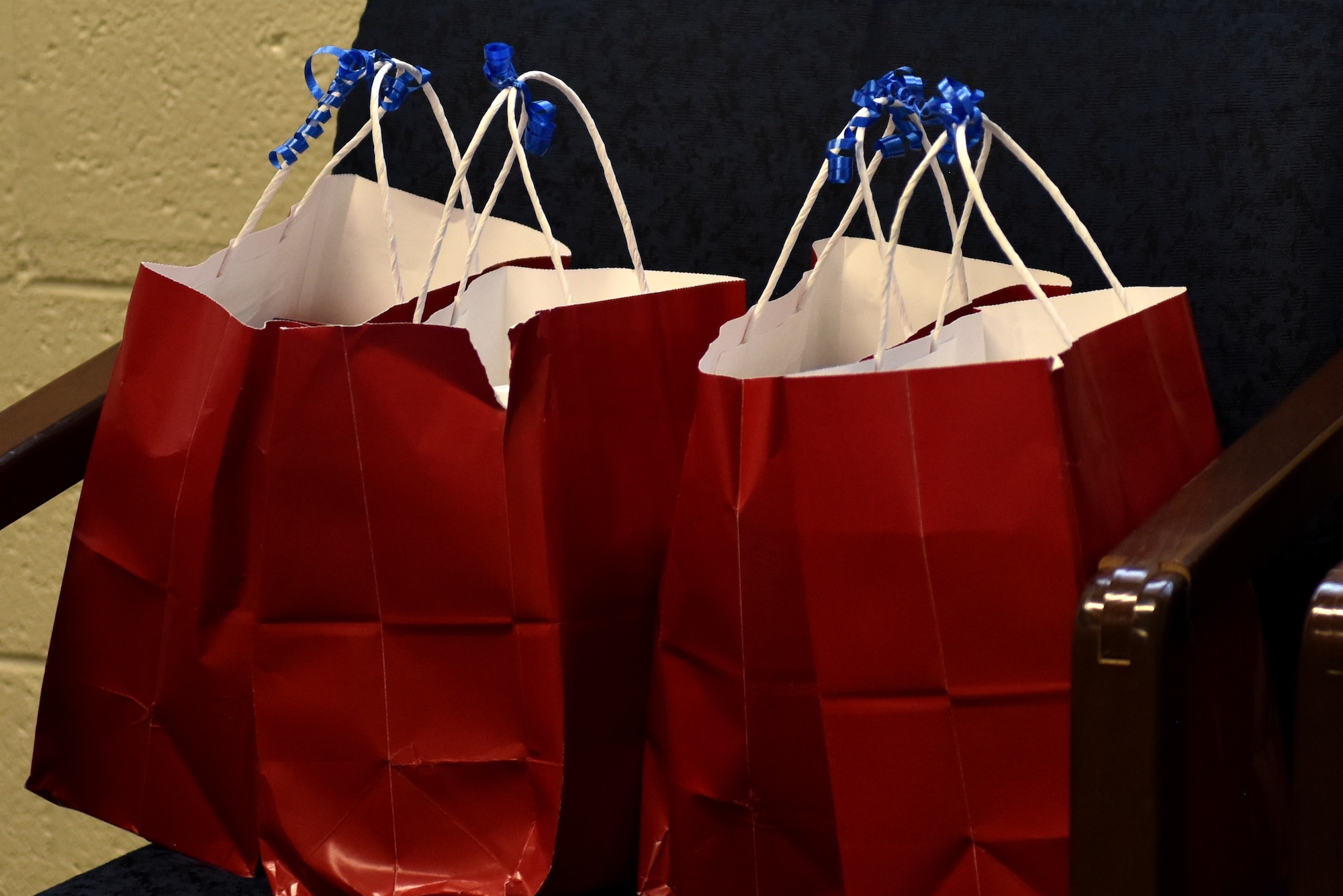 Goody bags from a local business sit on chairs before being given out to Airmen at the 17th Communications Squadron on Goodfellow Air Force Base, Texas, Nov. 17, 2020. The wing commander and command chief master sgt. traveled through multiple offices giving the bags to Airmen. (U.S. Air Force photo by Staff Sgt. Seraiah Wolf)