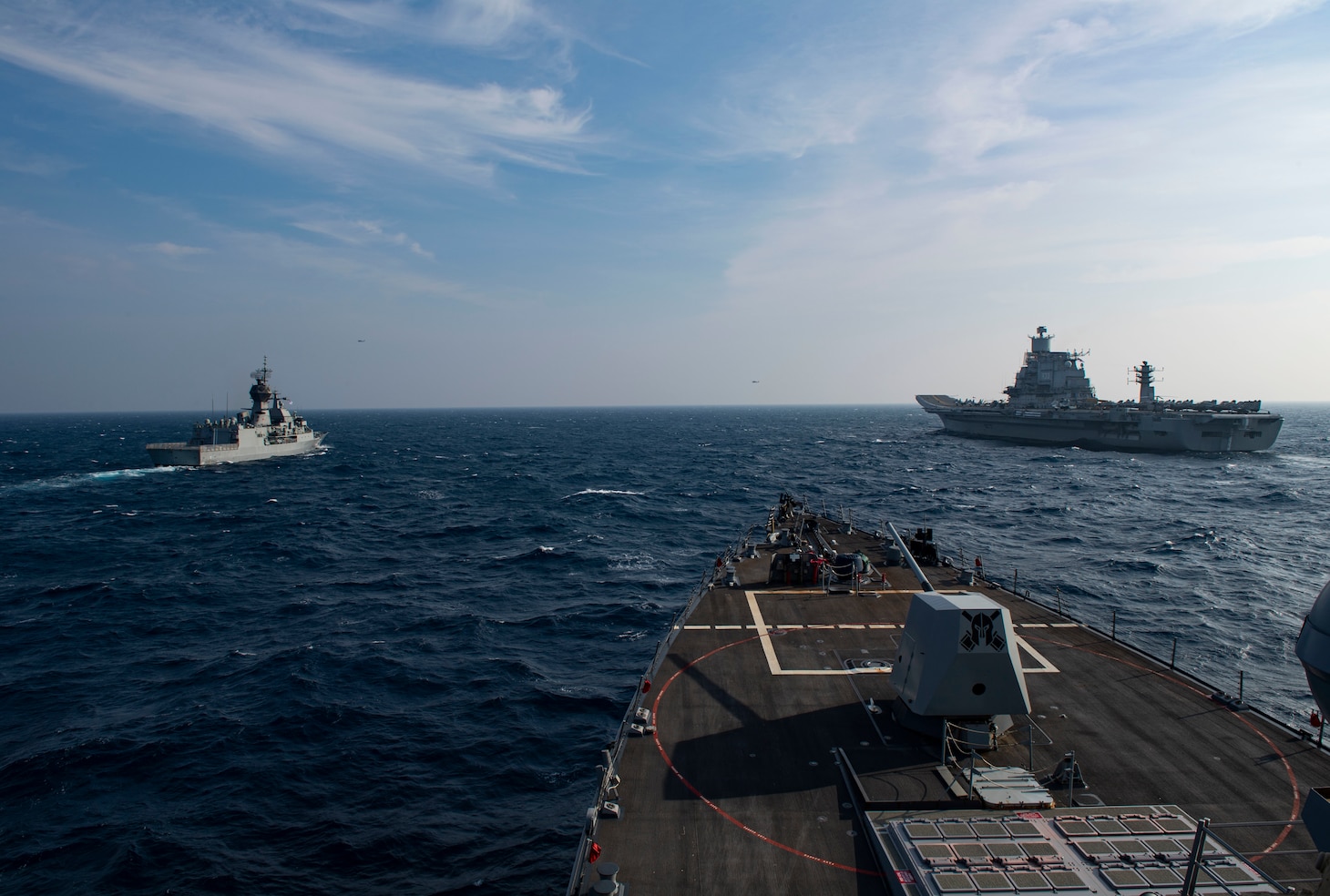 The guided-missile destroyer USS Sterett (DDG 104), the Royal Australian Navy frigate HMAS Ballarat (left) and the Indian Navy aircraft carrier INS Vikramaditya steam in formation in the North Arabian Sea during Malabar 2020.