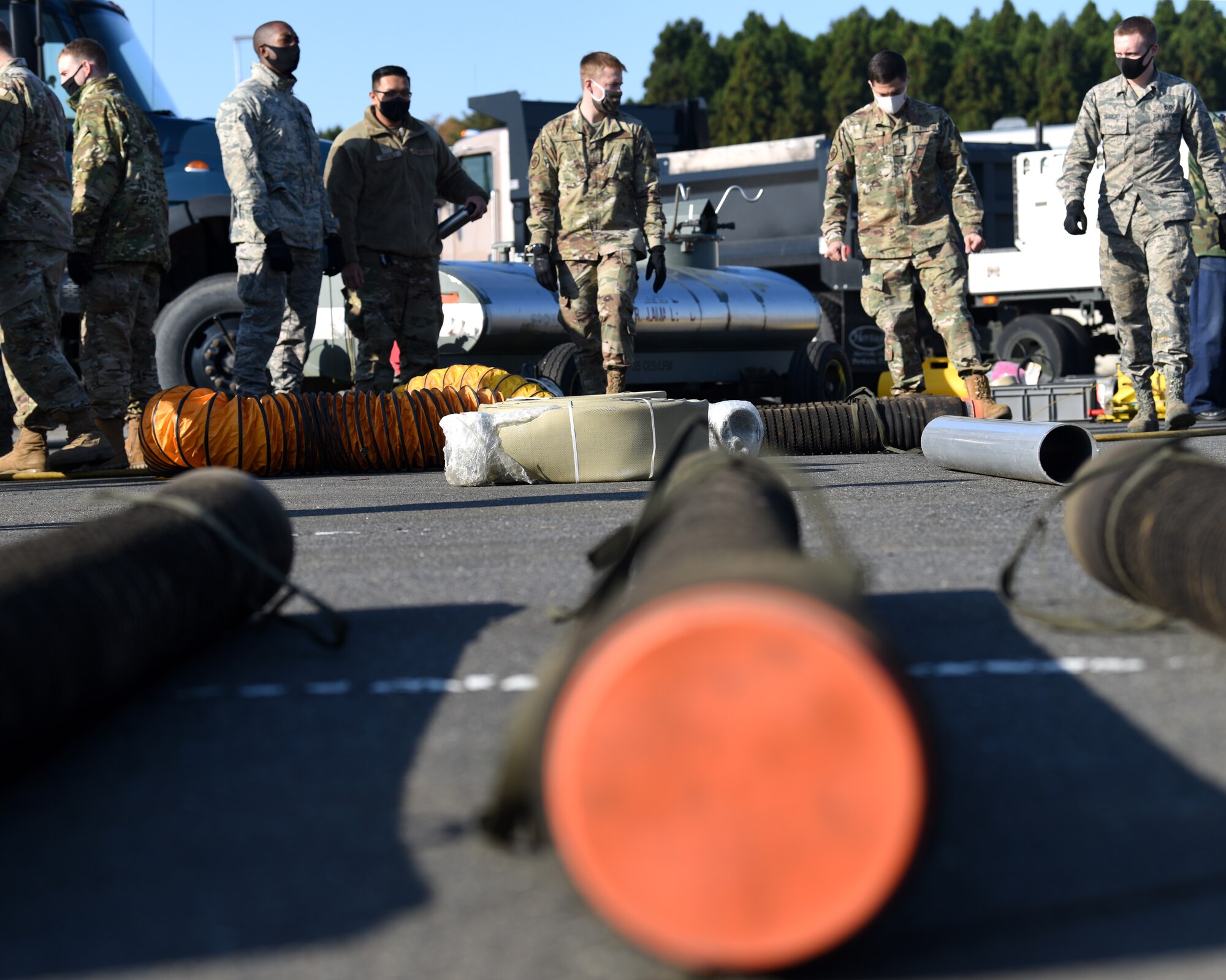 Individuals in uniform perform training outside