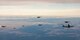 F-15Es and F-16s fly alongside a KC-46