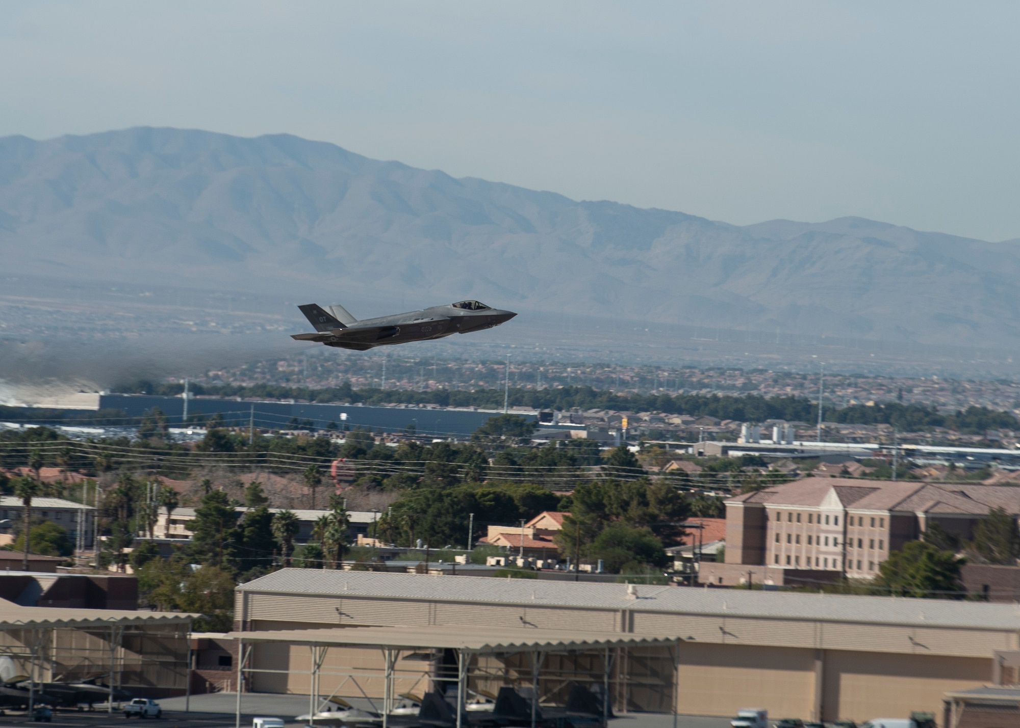 F-35 taking off over buildings