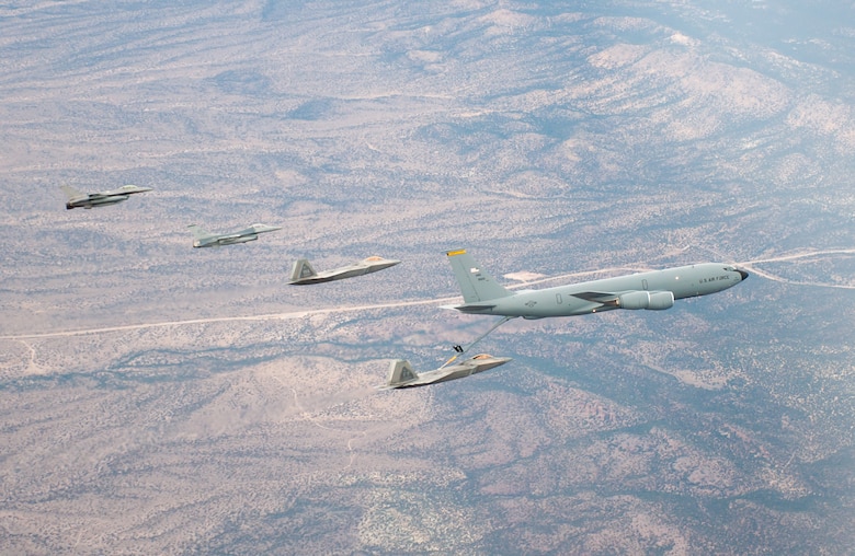 F-22s and F-16s refuel from a KC-136