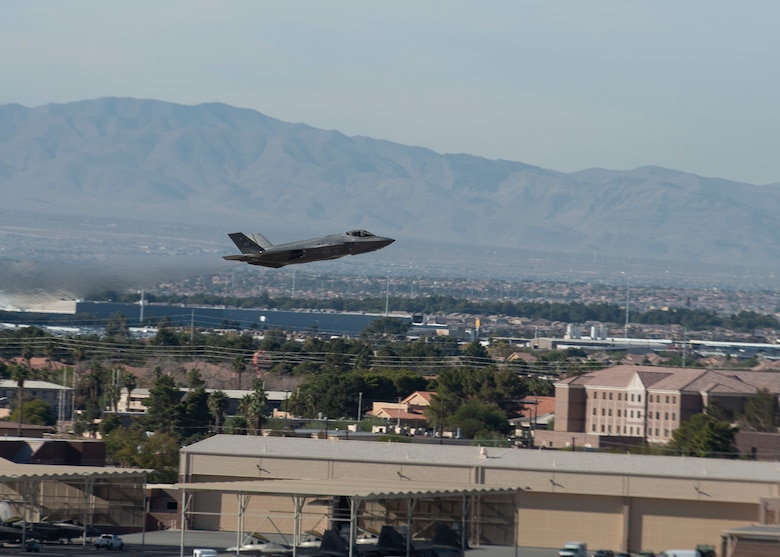 F-35 taking off over buildings