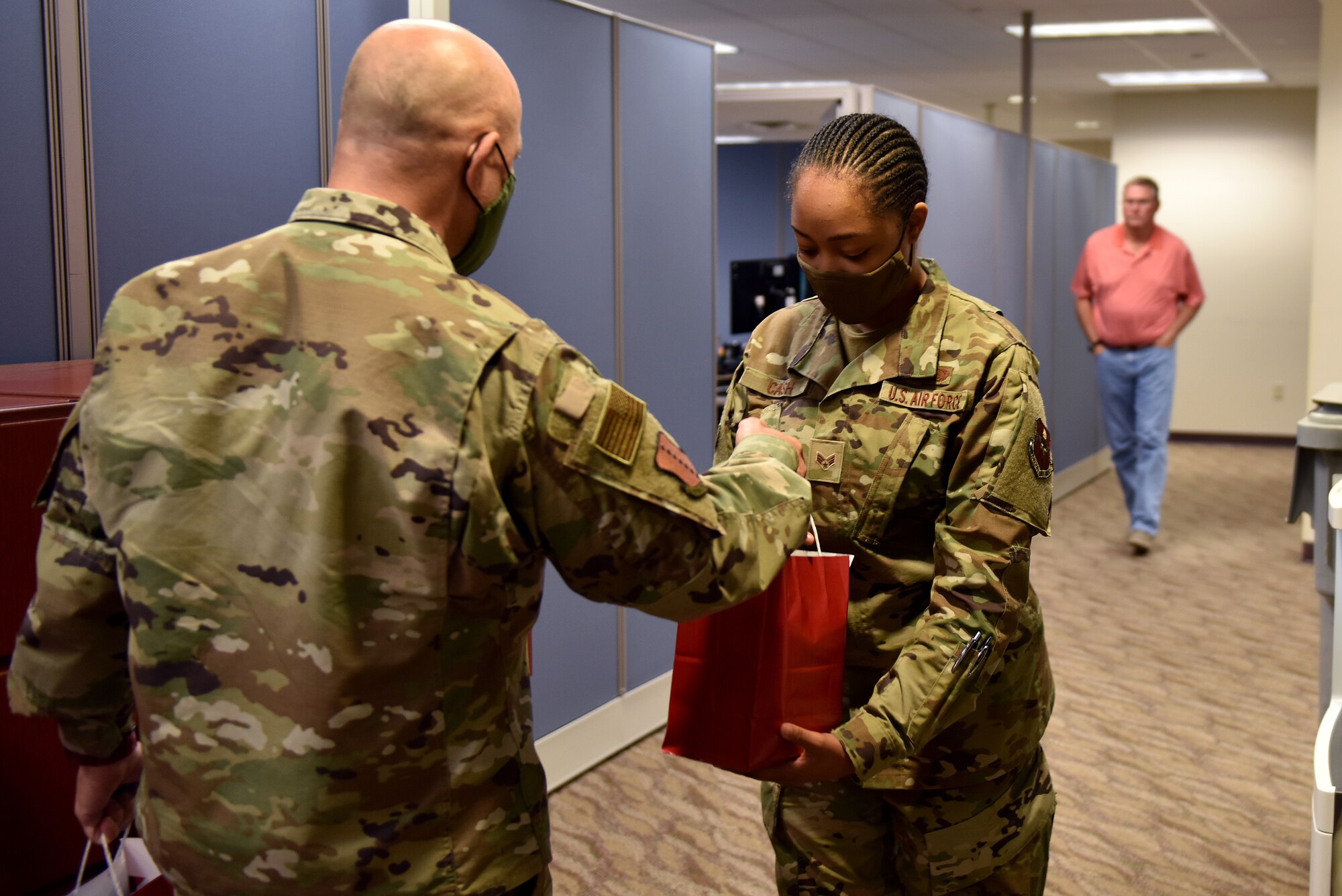 U.S. Air Force Col. Andres Nazario, 17th Training Wing commander, hands Senior Airman Brianna Cash a goody bag in the Norma Brown Building on Goodfellow Air Force Base, Texas, Nov. 17, 2020. The goody bags were filled with a variety of seasonal items such as; cookies, coffee, creamer, and a note from a community member thanking the military for their service. (U.S. Air Force photo by Staff Sgt. Seraiah Wolf)