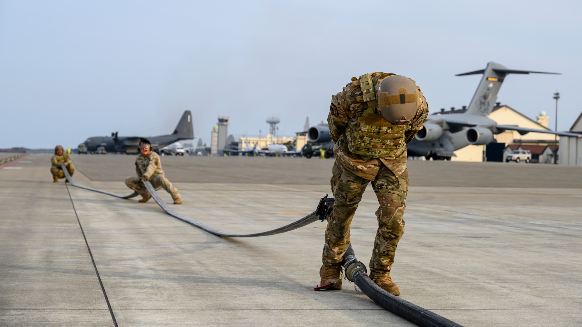 A U.S. Airman with the 1st Special Operations Squadron from Kadena Air Base, Japan, drains the gas from a fuel hose during a forward area refueling point (FARP) training at Misawa Air Base, Japan, Nov. 18, 2020. FARP, a specialty within the petroleum, oils and lubrication career field, trains Airmen to effectively refuel aircraft in remote locations when air-to-air refueling is not possible or when fueling stations are not accessible. (U.S. Air Force photo by Airman 1st Class China M. Shock)