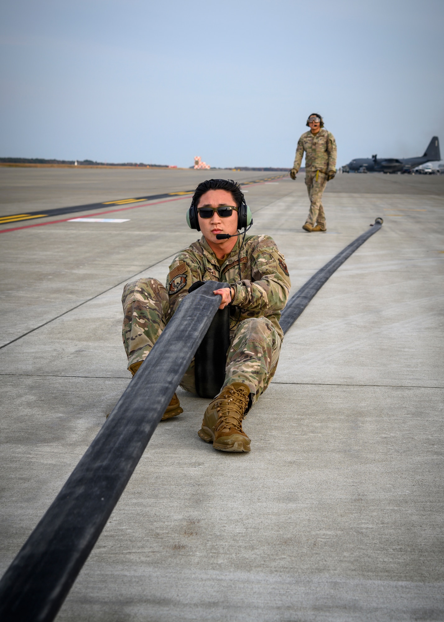 A U.S. Airman with the 1st Special Operations Squadron from Kadena Air Base, Japan, holds a fuel hose steady during a forward area refueling point (FARP) training at Misawa Air Base, Japan, Nov. 18, 2020. With FARP support, any accessible airfield or island can be used to replenish aircraft and get them back to the fight, delivering airpower lethality. (U.S. Air Force photo by Airman 1st Class China M. Shock)