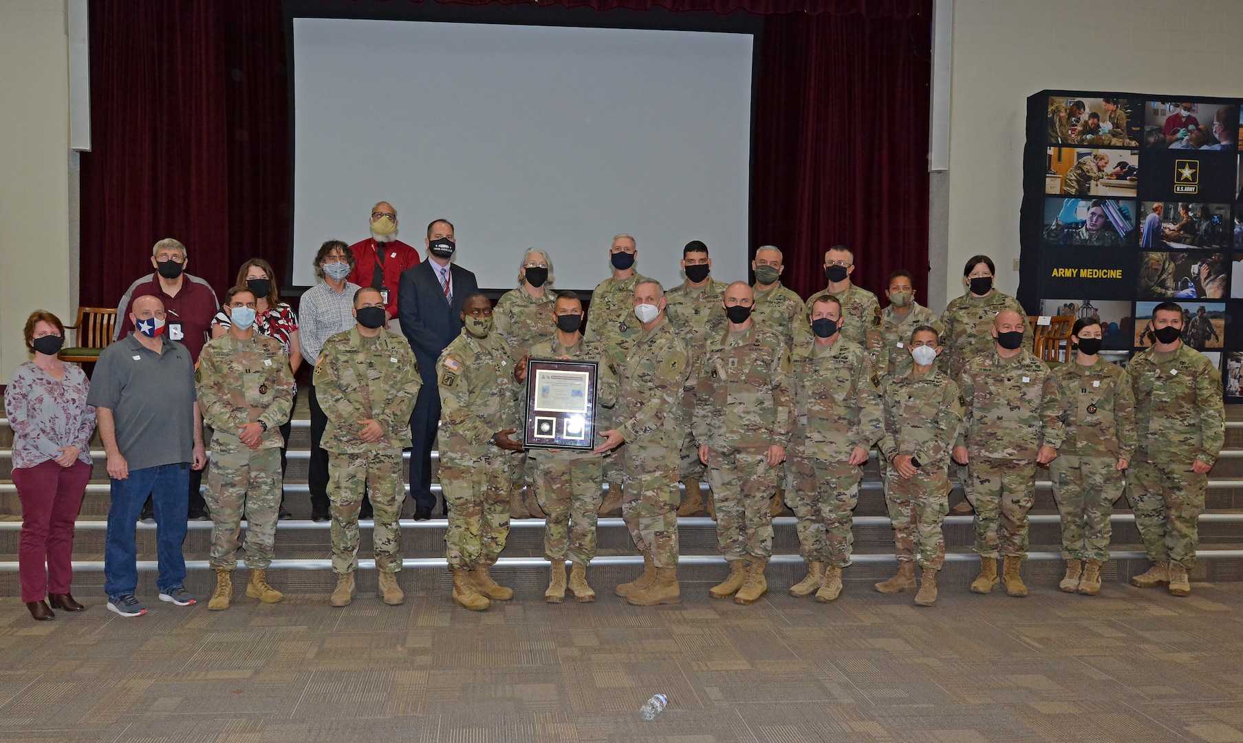 Lt. Gen. R. Scott Dingle, Surgeon General of the U.S. Army and commanding general, U.S. Army Medical Command; Maj. Johnny Paul, Department Chair, Combat Medic Specialist Training Program; and Maj. Gen. Dennis P. LeMaster, U.S. Army Medical Center of Excellence commander; pose for a group photo during the Third Quarter Fiscal Year 2020 Army Medicine Wolf Pack Award ceremony Nov. 9 at the Blesse Auditorium at Joint Base San Antonio-Fort Sam Houston.