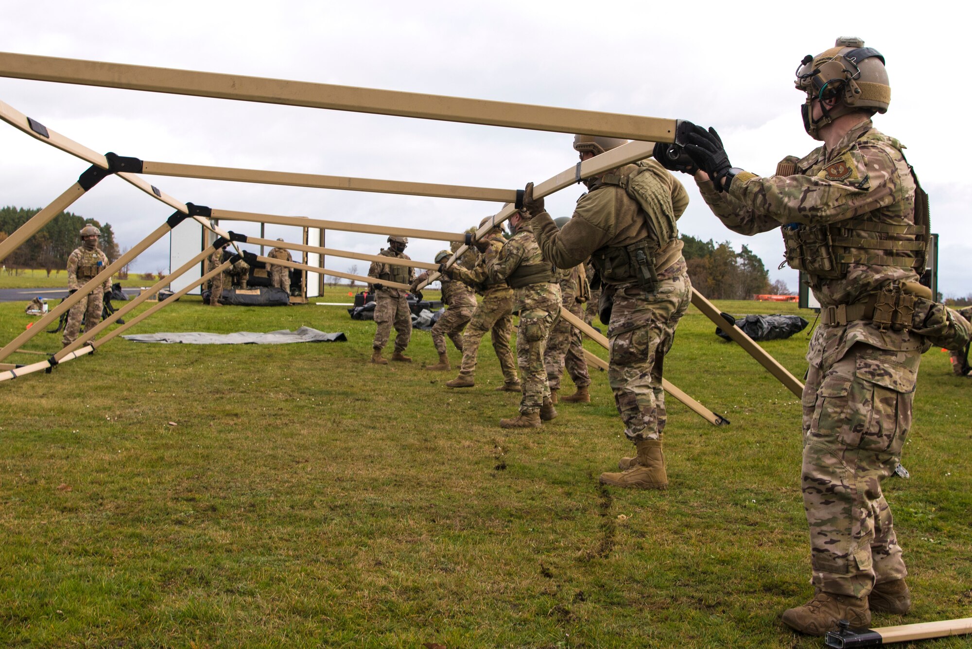 U.S. Airmen assigned to the 435th Contingency Response Group assemble a tent for a life support area during exercise Agile Wolf 21-01