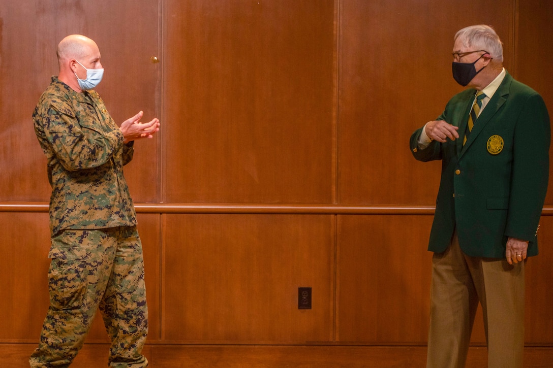 Maj. Jonathan Hansen, 4th Marine Aircraft Wing director of safety and standardization, catches a coin from Lt. Gen. Nicholas Kehoe, USAF (ret.), the national commander of the Order of the Daedalians, during an award ceremony on Nov. 13, 2020 at Marine Corps Support Facility New Orleans. Pilots with 4th MAW flew more than 20,000 hours with no Class A flight-related or aviation-ground mishaps, which placed it at the top of other competitive commands. (U.S. Marine Corps photo by Lance Cpl. Mitchell Collyer)