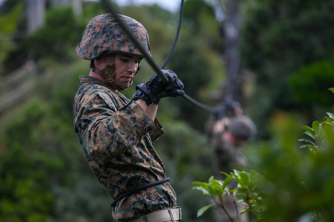 A U.S. Marine negotiates an obstacle at the Jungle Warfare Training Center at Camp Gonsalves, Okinawa, Japan, Nov. 13.