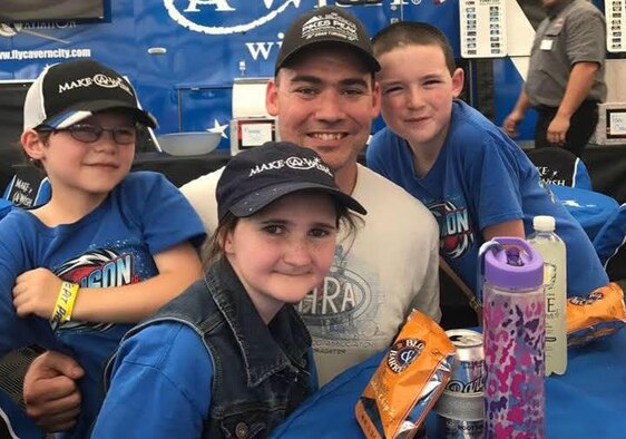 Staff Sgt. Jeffrey White, 7th Space Operations Squadron space system operator, and his children pose for a photo at Bandimere Speedway in Morrison, Colorado, June 2015. Through the Combined Federal Campaign, White was able to access the Make-A-Wish Foundation, because it was one of the organizations within the campaign. White’s family traveled to Walt Disney World in Orlando, Florida, where his daughter’s wish was granted by allowing her to spend time with her favorite Disney princess, Princess Jasmine. (U.S. Space Force courtesy photo)