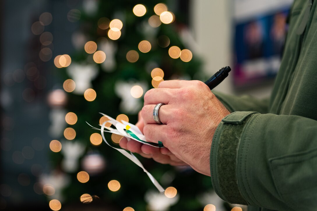 A photo of an Airman filling out a slip during an event