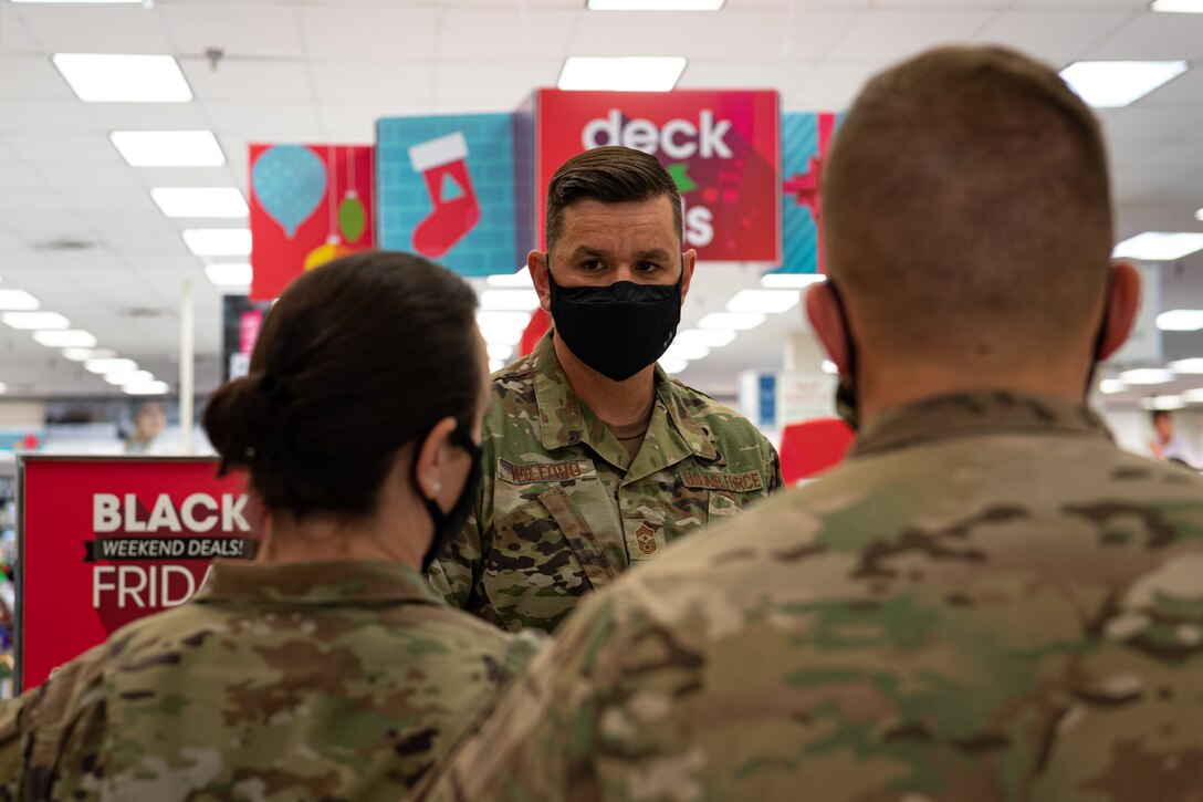 A photo of Airmen speaking with each other at an event